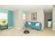 Bright living area with a comfortable blue sofa, stylish accents, and ample natural light at 2260 Santa Fe Dr, Greenfield, IN 46140