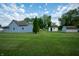 This backyard features a large grassy area and 2 sheds at 2358 Hovey St, Indianapolis, IN 46218