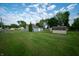 This backyard features a large grassy area and 2 sheds at 2358 Hovey St, Indianapolis, IN 46218