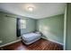 Compact bedroom featuring hardwood floors, neutral paint, and a comfortable air mattress at 2358 Hovey St, Indianapolis, IN 46218