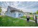 Well-maintained light blue home featuring a manicured lawn and neat landscaping at 2358 Hovey St, Indianapolis, IN 46218