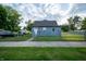 Charming exterior of a light blue home with well-maintained lawn and picket fence at 2358 Hovey St, Indianapolis, IN 46218