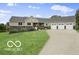 Charming single-story home with a three-car garage, stone accents and a lush lawn at 25050 State Road 213, Cicero, IN 46034