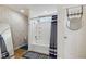 Bright bathroom with a shower-tub combination and decorative striped shower curtain at 2509 Cedarmill Dr, Franklin, IN 46131