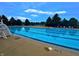 Large community pool with clear blue water, lifeguard stand, and lounge chairs at 2509 Cedarmill Dr, Franklin, IN 46131