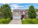 Charming two-story home featuring brick and siding, a two-car garage, and a well-maintained front yard at 2509 Cedarmill Dr, Franklin, IN 46131