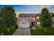 Charming two-story home with a brick and siding facade, attached garage, and beautifully landscaped front yard at 2509 Cedarmill Dr, Franklin, IN 46131