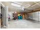 Spacious garage with storage shelves, two trash cans, and a roll-up door at 2509 Cedarmill Dr, Franklin, IN 46131