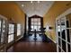 Gym with neutral yellow walls, light hardwood floors, multiple machines and an exit to the left at 2509 Cedarmill Dr, Franklin, IN 46131