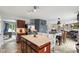 Spacious kitchen featuring a center island with seating, granite countertops, and a view into the dining and living spaces at 2509 Cedarmill Dr, Franklin, IN 46131