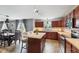 Open concept kitchen with stainless steel appliances, countertop island, dining area, and sliding glass door at 2509 Cedarmill Dr, Franklin, IN 46131