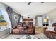 Open concept: Living room with brown leather seating opens to the kitchen at 2509 Cedarmill Dr, Franklin, IN 46131