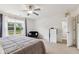 Bright primary bedroom with a large window, ceiling fan, and ensuite bathroom access at 2509 Cedarmill Dr, Franklin, IN 46131