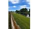 Scenic view of the pond behind the house. Well-manicured lawn with a fence in the foreground at 2509 Cedarmill Dr, Franklin, IN 46131