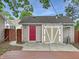 Outdoor backyard shed featuring a red door and white doors with a concrete patio and deck at 2612 E Northgate St, Indianapolis, IN 46220