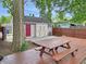View of the backyard with a picnic table, shed, and mature tree providing shade at 2612 E Northgate St, Indianapolis, IN 46220