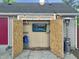 Backyard shed with an outdoor television, patio heater, and string lights for outdoor enjoyment at 2612 E Northgate St, Indianapolis, IN 46220