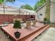 Landscaped backyard with a wooden deck, seating area, and privacy fence at 2612 E Northgate St, Indianapolis, IN 46220
