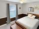 Cozy bedroom featuring a wood bed frame, decorative pillows, and a ceiling fan at 2612 E Northgate St, Indianapolis, IN 46220