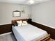 Bedroom featuring a wood bed frame, decorative pillows, and a night stand with lamp at 2612 E Northgate St, Indianapolis, IN 46220