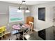 Bright dining area with a round table, white chairs, and natural light from a large window at 2612 E Northgate St, Indianapolis, IN 46220