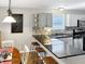 Well-lit kitchen with granite countertops, stainless steel appliances, gray cabinets, and stylish breakfast bar seating at 2612 E Northgate St, Indianapolis, IN 46220