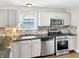 Well-lit kitchen with granite countertops, stainless steel appliances, and white cabinets at 2612 E Northgate St, Indianapolis, IN 46220