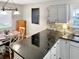 Stylish kitchen featuring granite countertops, white cabinets, and modern appliances at 2612 E Northgate St, Indianapolis, IN 46220