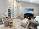 Bright living room with vaulted ceilings, television and fireplace, comfortable seating, and a view of the kitchen at 2612 E Northgate St, Indianapolis, IN 46220