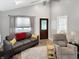 Spacious living room with vaulted ceiling, neutral paint, comfortable seating, and natural light from large windows at 2612 E Northgate St, Indianapolis, IN 46220