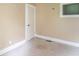A view of a bedroom including a light tan wall and carpet, and a white door and window at 2823 Boulevard Pl, Indianapolis, IN 46208