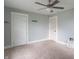 Bedroom featuring carpeted floors, a ceiling fan, two doors, and light blue walls at 2823 Boulevard Pl, Indianapolis, IN 46208
