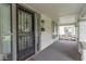 Front porch featuring a security door, windows, an exterior light, and architectural stone details at 2823 Boulevard Pl, Indianapolis, IN 46208