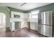 View of a kitchen featuring white cabinets, stainless steel appliances, and a window at 2823 Boulevard Pl, Indianapolis, IN 46208