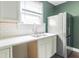 A view of a kitchen featuring white subway tiles, a stainless steel sink, and stainless steel fridge at 2823 Boulevard Pl, Indianapolis, IN 46208