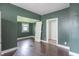 Living room with dark hardwood flooring and a window with natural light at 2823 Boulevard Pl, Indianapolis, IN 46208