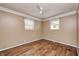 Neutral bedroom with a ceiling fan, hardwood flooring and two windows at 2840 Denison St, Indianapolis, IN 46241