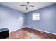 Blue bedroom features hardwood flooring and a ceiling fan at 2840 Denison St, Indianapolis, IN 46241