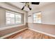 Cozy bedroom with hardwood floors, ceiling fan, and natural light from two windows at 2840 Denison St, Indianapolis, IN 46241