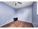 Blue bedroom features hardwood flooring, ceiling fan, and natural light at 2840 Denison St, Indianapolis, IN 46241