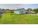 View of the detached garage with a well-kept lawn and a glimpse of the surrounding neighborhood at 2840 Denison St, Indianapolis, IN 46241