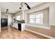 Bright kitchen with white cabinets, modern appliances, and wood-look flooring at 2840 Denison St, Indianapolis, IN 46241