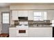 Practical kitchen with white cabinets, updated countertop and appliances at 2840 Denison St, Indianapolis, IN 46241