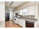 Clean kitchen with white cabinetry, black appliances, and updated backsplash at 2840 Denison St, Indianapolis, IN 46241