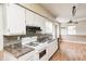 Functional kitchen featuring white cabinets, appliances, and a breakfast bar at 2840 Denison St, Indianapolis, IN 46241