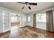 Bright living room with hardwood floors, ceiling fan, and opening to another room at 2840 Denison St, Indianapolis, IN 46241