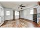 Bright living room featuring hardwood floors, large windows, and a ceiling fan at 2840 Denison St, Indianapolis, IN 46241
