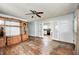 Spacious living room with hardwood floors, ceiling fan, and opening to kitchen at 2840 Denison St, Indianapolis, IN 46241