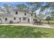 Spacious backyard features a patio with seating, lush green grass, and mature trees at 3030 E 236Th St, Cicero, IN 46034