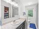 Bright bathroom featuring marble countertops, vanity, towel rack, and a window view to the exterior at 3030 E 236Th St, Cicero, IN 46034